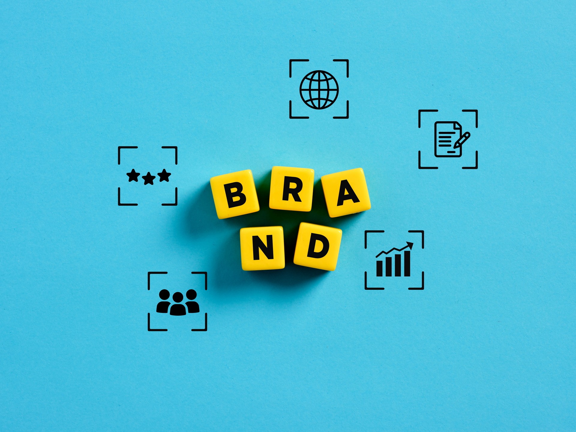 Branding and brand management. The word brand on yellow cubes with business symbols.